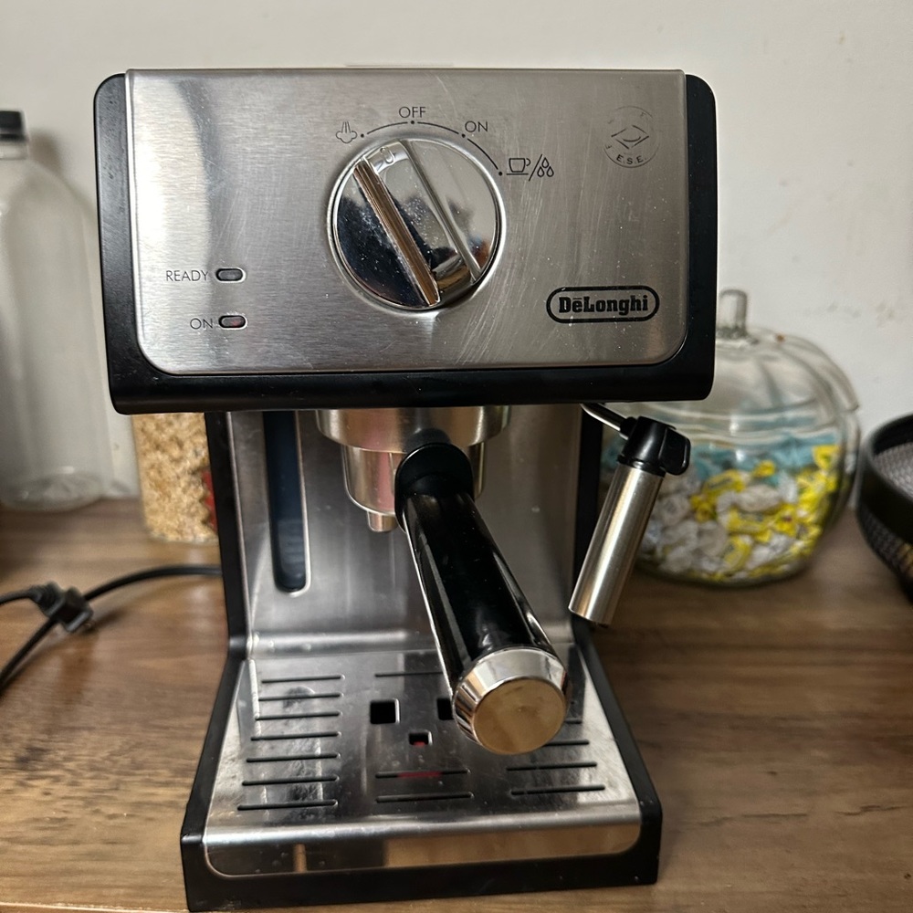 Black espresso maker with milk frother. Gently used.